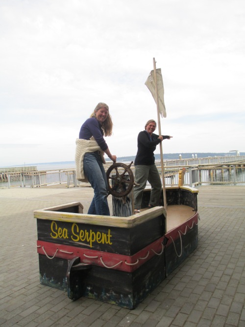 We finally found our vessel north!  Megan's at the wheel and Cindy's on watch for logs, deadheads, container ships, growlers, and bergy bits.  (Photo by Ruth Brede.)